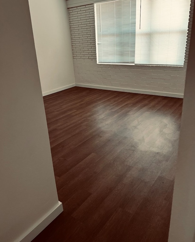 126 Coliseum Dr, Snyder, TX 79549 - unfurnished room with baseboards and dark wood-style flooring