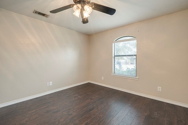 empty room with ceiling fan and dark wood-type flooring