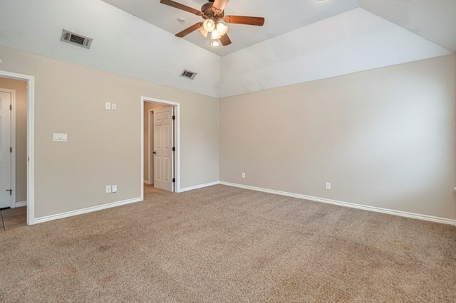 spare room featuring ceiling fan, light colored carpet, and vaulted ceiling