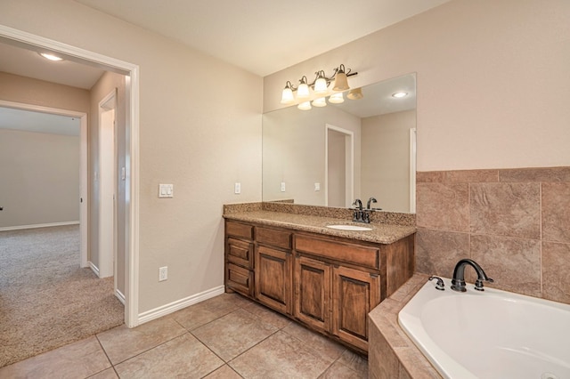 bathroom with vanity, tile patterned floors, and tiled tub