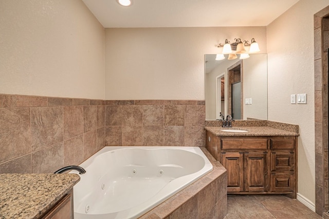 bathroom featuring vanity and a relaxing tiled tub