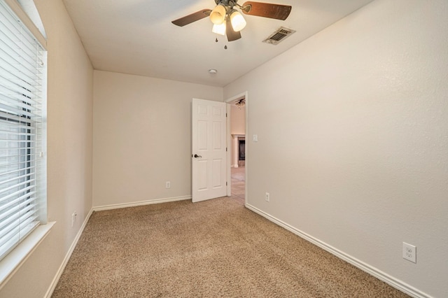 carpeted empty room with ceiling fan