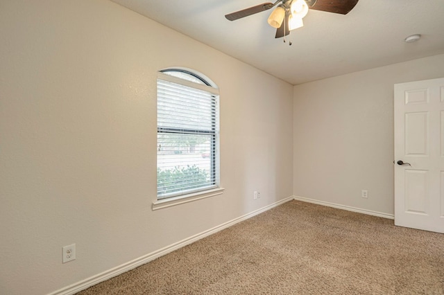 spare room with ceiling fan and carpet