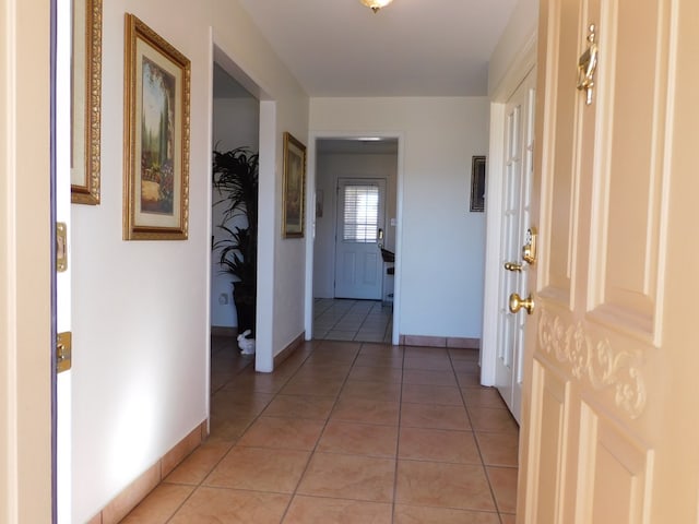 hall featuring light tile patterned floors