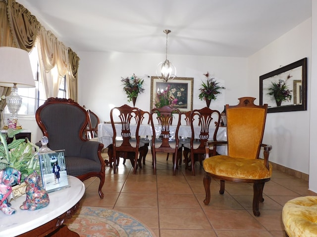 tiled dining room featuring a chandelier