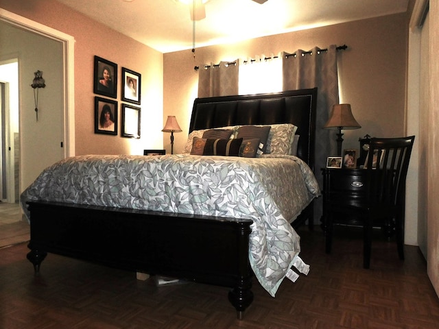 bedroom featuring ceiling fan and parquet floors