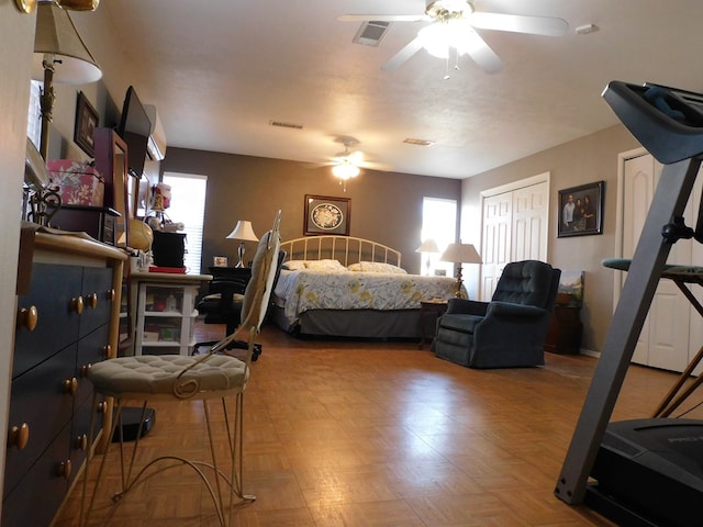 bedroom with ceiling fan and parquet flooring