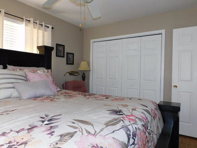 bedroom featuring ceiling fan, parquet flooring, and a closet