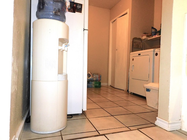 clothes washing area featuring light tile patterned floors