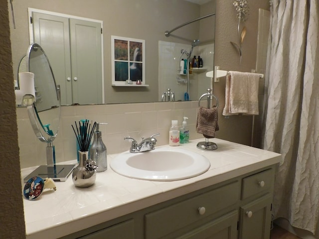 bathroom featuring backsplash, vanity, and walk in shower