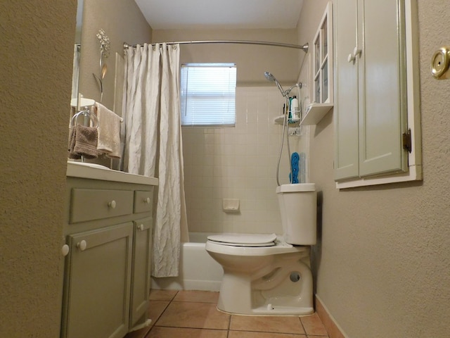 bathroom featuring tile patterned flooring, toilet, and shower / tub combo