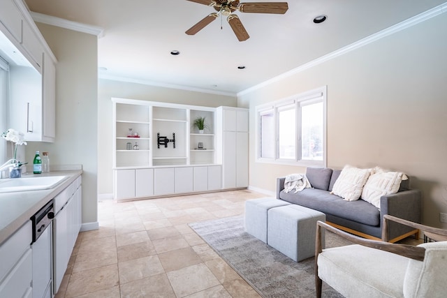 living room featuring ceiling fan, crown molding, and sink