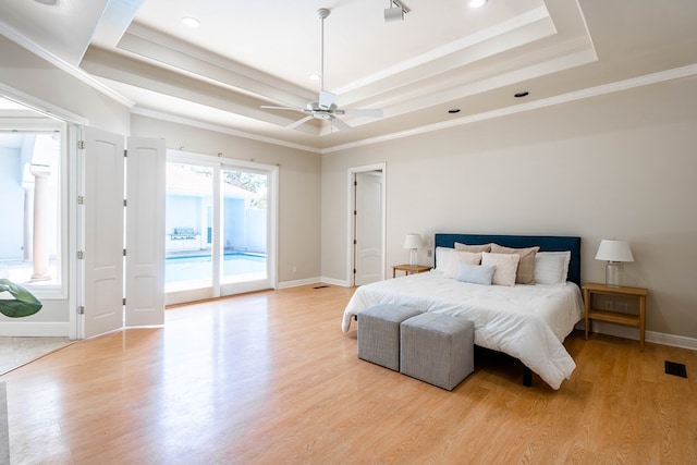 bedroom with a tray ceiling, ceiling fan, and crown molding