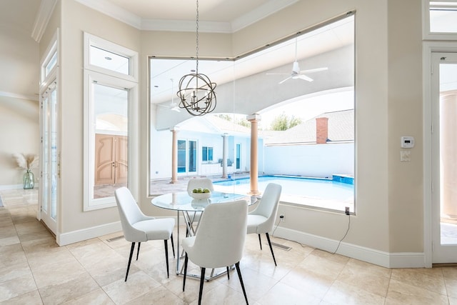 dining space with ceiling fan with notable chandelier, ornate columns, and crown molding