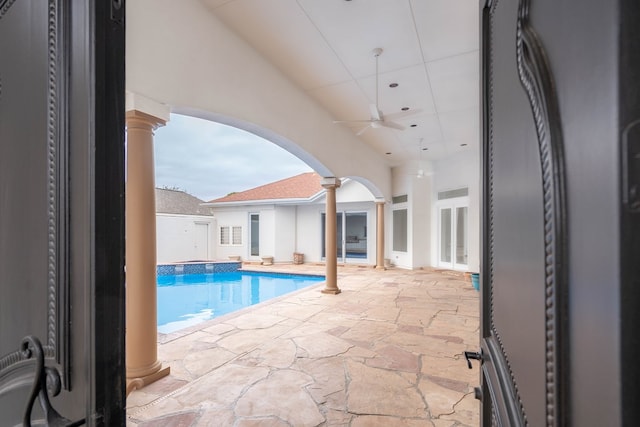 view of swimming pool featuring ceiling fan and a patio