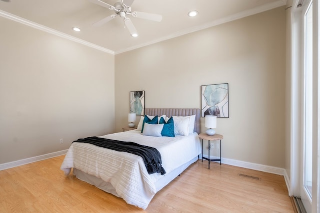 bedroom with ceiling fan, crown molding, and light wood-type flooring