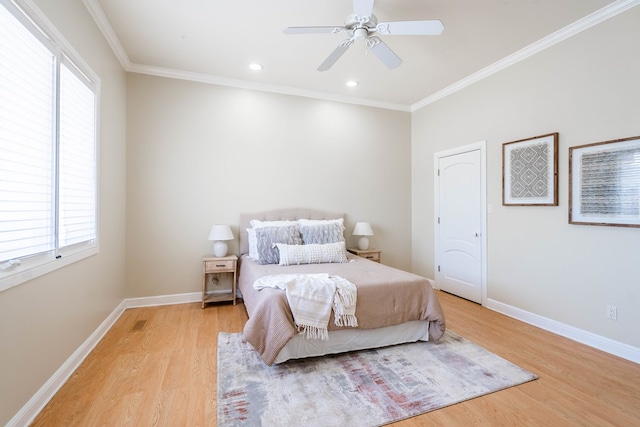 bedroom featuring multiple windows, light wood-type flooring, ceiling fan, and ornamental molding