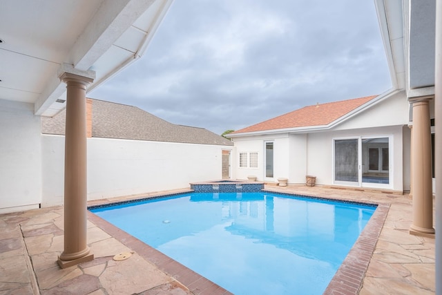 view of pool with an in ground hot tub