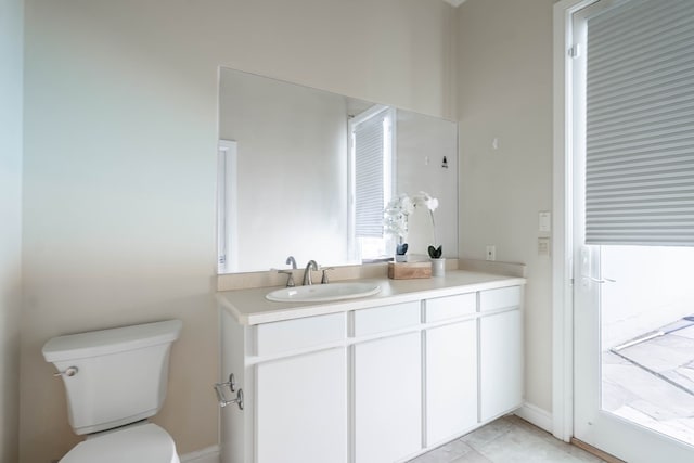 bathroom featuring tile patterned flooring, vanity, and toilet