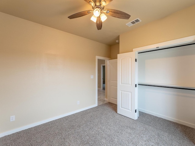 unfurnished bedroom featuring a closet, visible vents, light carpet, ceiling fan, and baseboards