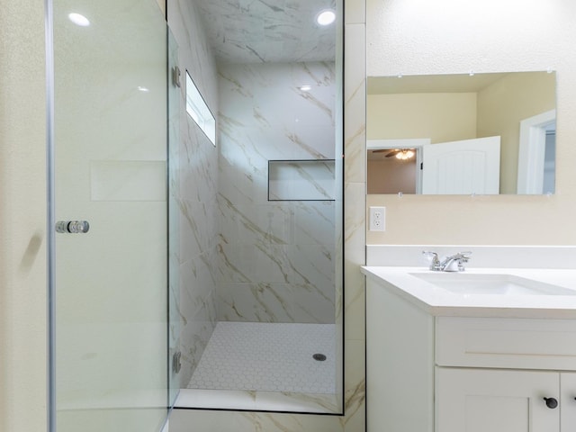 bathroom with a shower stall and vanity