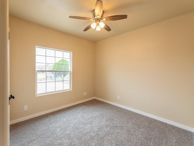 unfurnished room featuring ceiling fan, carpet flooring, and baseboards