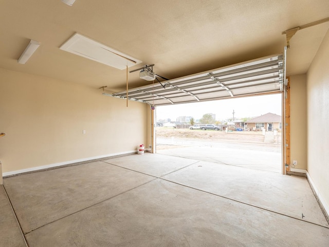 garage featuring baseboards and a garage door opener