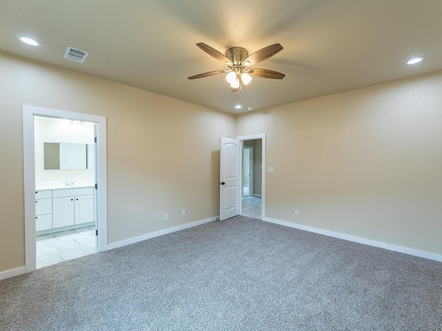 spare room with ceiling fan, recessed lighting, light carpet, visible vents, and baseboards