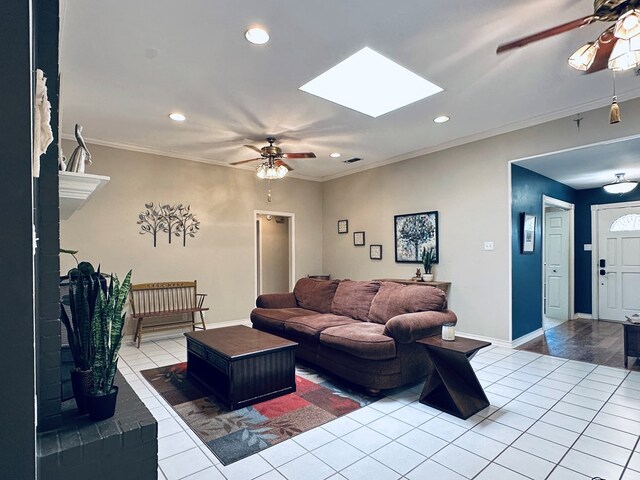 3320 Lancewood Ln, Odessa, TX 79762 - living area with a ceiling fan, a skylight, light tile patterned flooring, crown molding, and a brick fireplace
