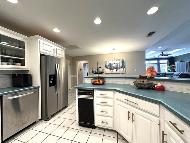 3320 Lancewood Ln, Odessa, TX 79762 - kitchen featuring appliances with stainless steel finishes, decorative backsplash, light tile patterned flooring, white cabinetry, and recessed lighting