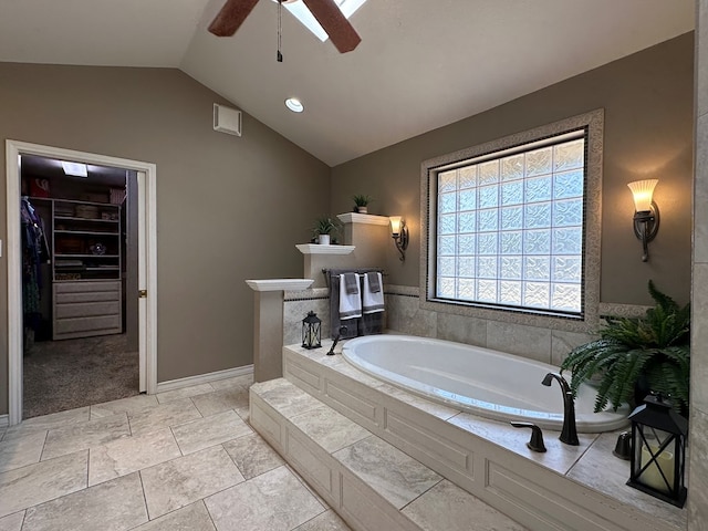 3320 Lancewood Ln, Odessa, TX 79762 - bathroom featuring ceiling fan, a bath, vaulted ceiling, and a spacious closet