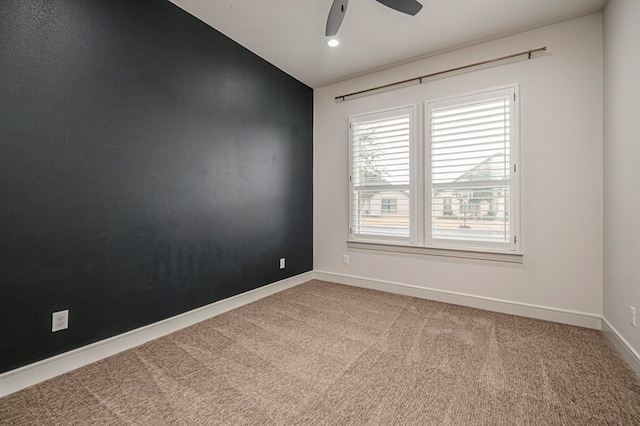 carpeted spare room with lofted ceiling and ceiling fan