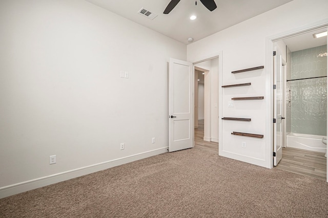 unfurnished bedroom featuring ensuite bathroom, carpet, and ceiling fan