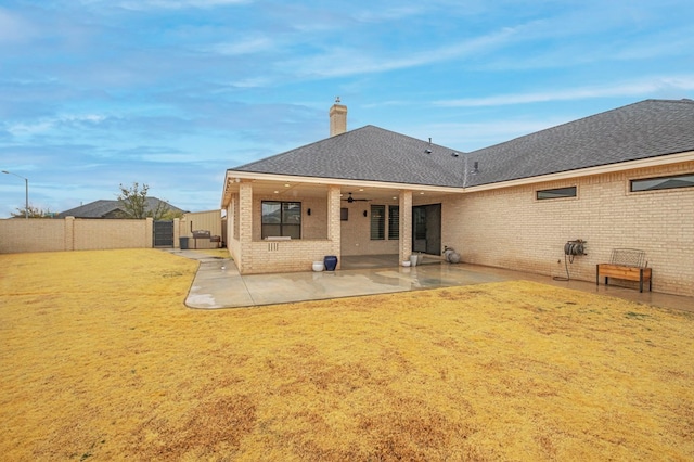 back of house with a yard, a patio, and ceiling fan