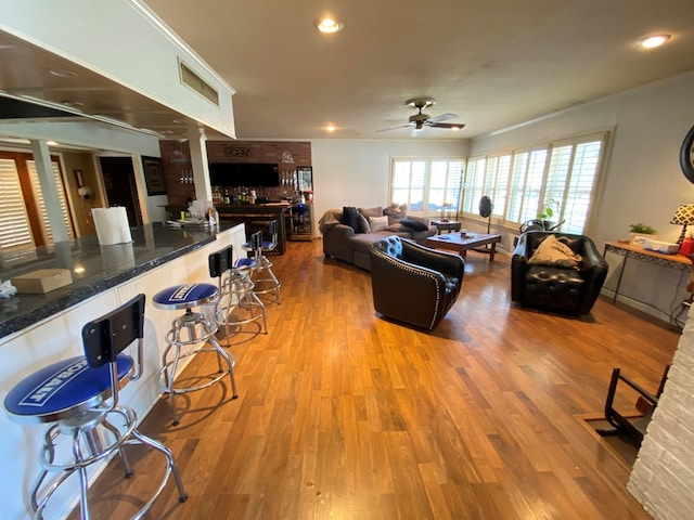 living room with hardwood / wood-style floors and ceiling fan