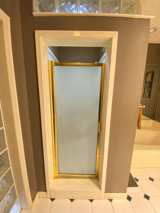 bathroom with a shower with door