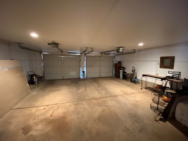 garage featuring electric panel and a garage door opener