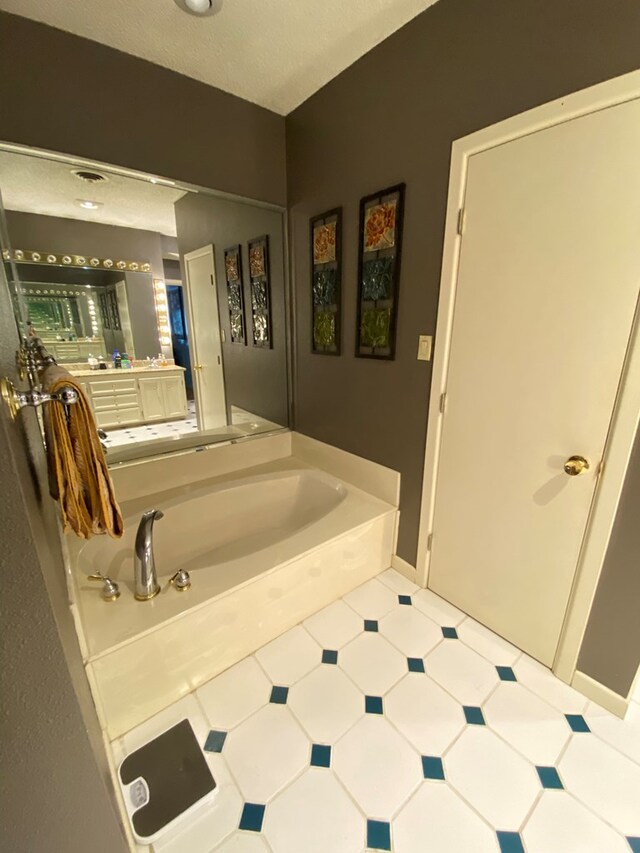 bathroom with a bathing tub and vanity