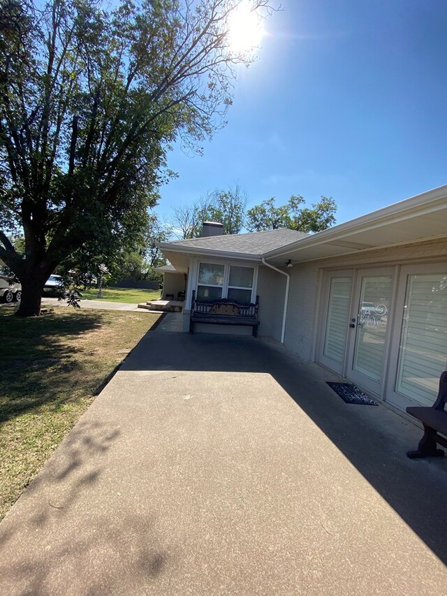 view of side of home with a lawn