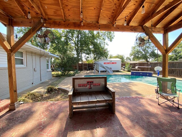 view of patio / terrace with a fenced in pool