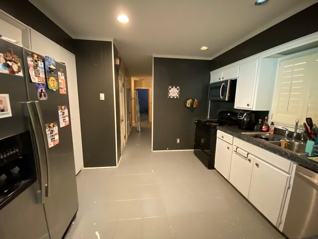 kitchen with appliances with stainless steel finishes, white cabinetry, crown molding, and sink