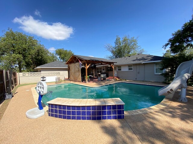 view of pool featuring a gazebo, a water slide, and a patio