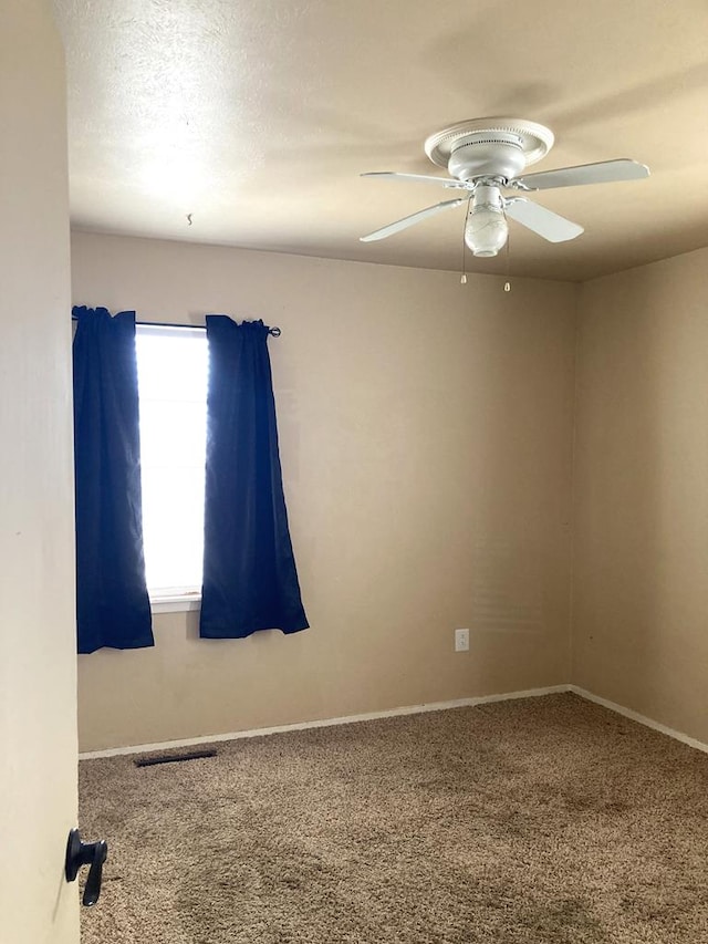 unfurnished room featuring a textured ceiling, ceiling fan, and carpet flooring