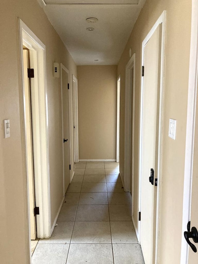 hall featuring light tile patterned floors