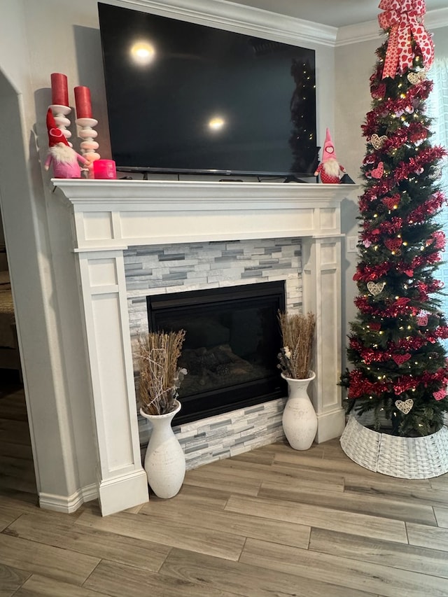 details with crown molding, a fireplace, and wood-type flooring