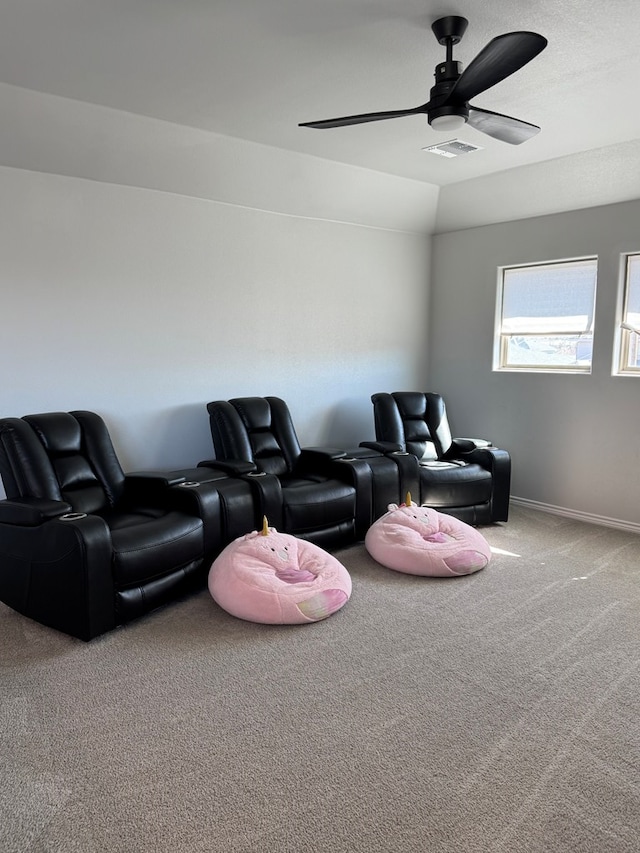 carpeted cinema room featuring lofted ceiling and ceiling fan