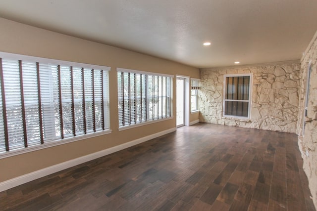 unfurnished room featuring a textured ceiling and dark hardwood / wood-style floors