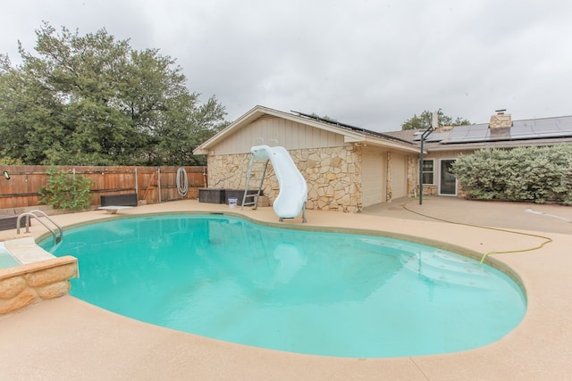 view of pool featuring a patio area and a water slide