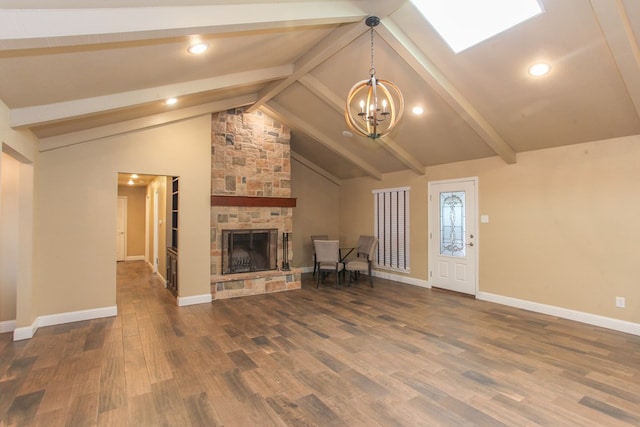 unfurnished living room featuring a fireplace, dark hardwood / wood-style flooring, beamed ceiling, and a notable chandelier