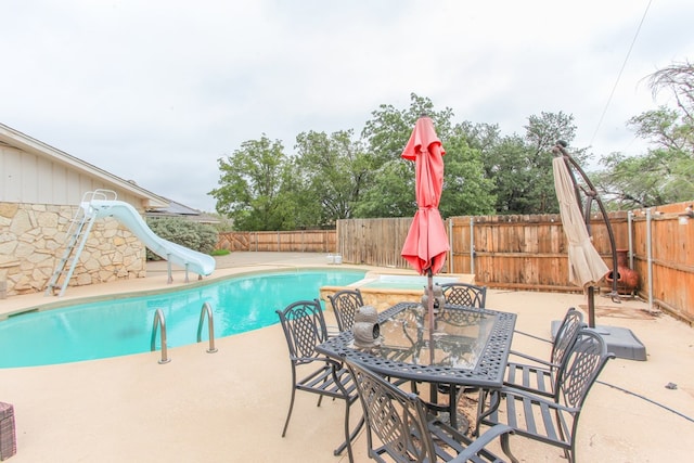 view of swimming pool featuring a patio area and a water slide